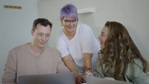 Inspired modern workers with gadgets at table. Inspired couple with manager Stock Footage 139593481
