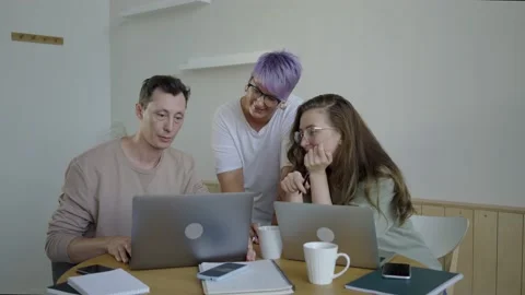 Inspired modern workers with gadgets at table. Inspired couple with manager Stock Footage 139593506