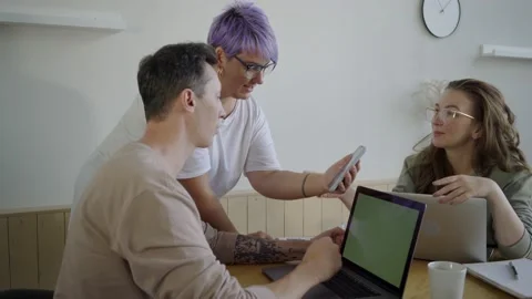 Inspired modern workers with gadgets at table. Inspired couple with manager Stock Footage 139593535