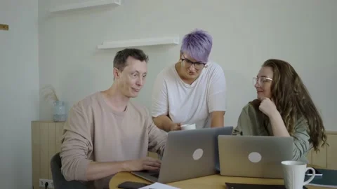 Inspired modern workers with gadgets at table. Inspired couple with manager Stock Footage 139593647