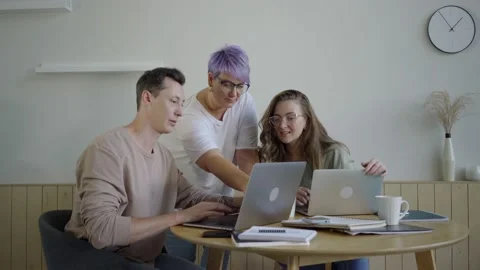 Inspired modern workers with gadgets at table. Inspired couple with manager Stock Footage 139593664