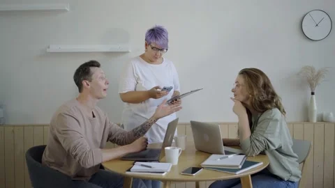 Inspired modern workers with gadgets at table. Inspired couple with manager Stock Footage 139593815