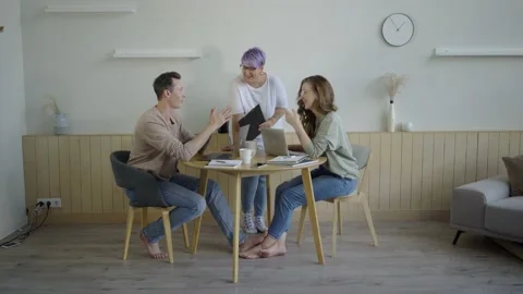Inspired modern workers with gadgets at table. Inspired couple with manager Stock Footage 139593882