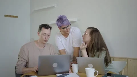 Inspired modern workers with gadgets at table. Inspired couple with manager Stock Footage 139593892