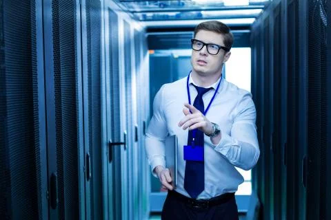 Inspired operator searching for the right server cabinet Stock Photos
