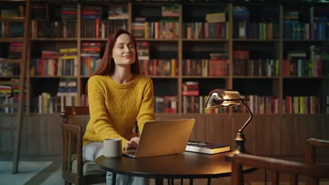 Inspired red-haired female author writing her book on laptop in coffee shop Stock Footage 340267100