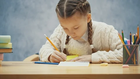 Inspired schoolkid is writing, making mistake and erasing it. Stock Footage 113069909