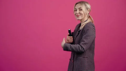The inspired secretary keeps a diary in her hand, in profile, smiles broadly at Stock Footage 150316702