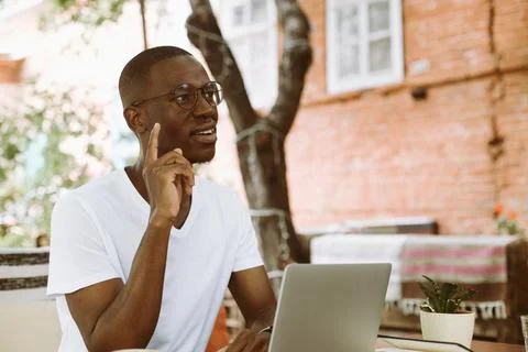 Inspired, smiling multicultural, mix raced man indexing and pointing up, getting Stock Photos
