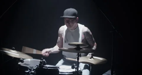 Inspired young man playing drum set with drumsticks on stage Stock Footage 249853115