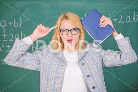 Inspiring educator spark motivation. Educator woman hold book and pen chalkboard Stock Photos