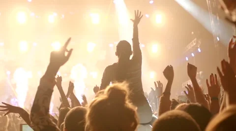 Inspiring girl at a concert raising her hands Stock Footage