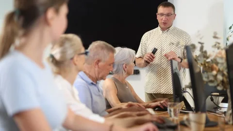 Inspiring instructor leading computer session for older adults. Concept of Stock Footage 330039214