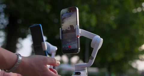 Insta360 Flow vs DJI Osmo Mobile modern gimbals with cell phones installed Video stock 246616937