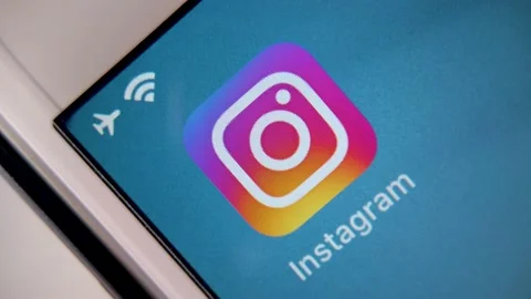 Instagram on iPhone screen from vertical high angle spinning shot. Video stock 139572629