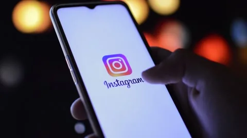 instagram logo icon on a phone in a nigh... | Stock Video | Pond5