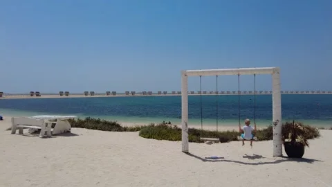 Instagramable Swing by the Palm Jebel Ali Beach, Dubai, United Arab Emirates, Stock Footage 242914115