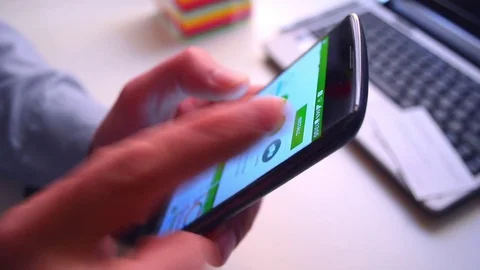 Install mobile app. Man holding smartphone, press button on the screen, load app 스톡 동영상 74070604