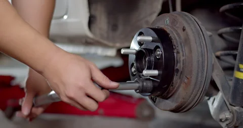 Install the nut onto the adapter wheel and tighten with a wrench. Stock Footage 259838651