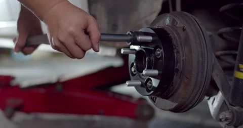 Install the nut onto the adapter wheel and tighten with a wrench. Stock Footage 267024159