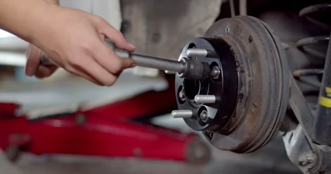 Install the nut onto the adapter wheel and tighten with a wrench. Stock Footage 267024293