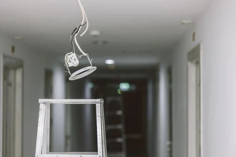 Install replace fix or repair ceiling down lights bulb danger area with elect Stock Photos