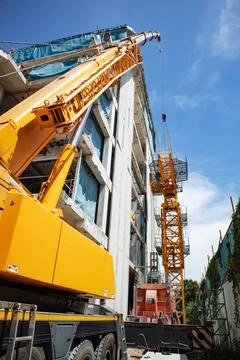 Install a tower crane at the construction site by using a mobile crane for .. Stock Photos