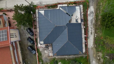 Installation of anthracite metal roofing tiles on a complex building. Stock Footage 330133564