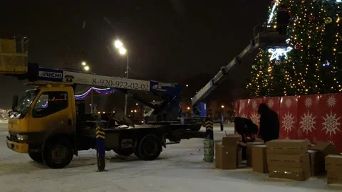 Installation of an artificial Christmas tree street view snowfall Stock Footage 226392369