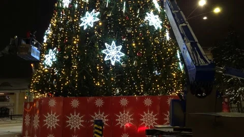 Installation of an artificial Christmas tree street view snowfall Stock Footage 226393048