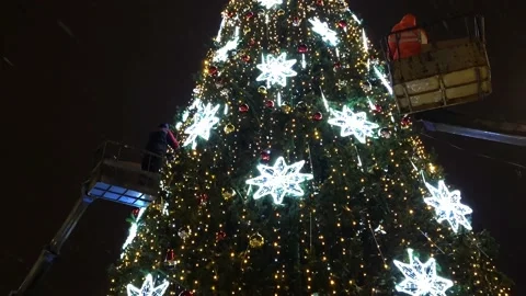 Installation of an artificial Christmas tree street view snowfall Stock Footage 226393440