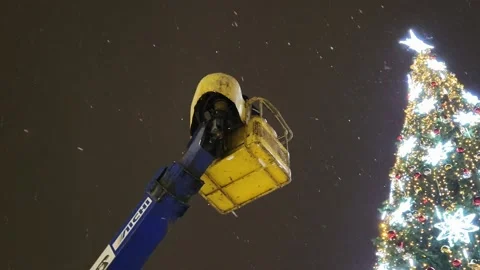 Installation of an artificial Christmas tree street view snowfall Stock Footage 226394049