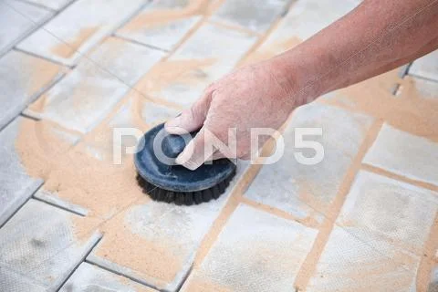 Installation of brick platform - smoothing-out with sand Stock Photos