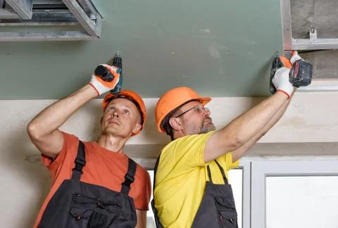 Installation of ceiling drywall. Stock Photos