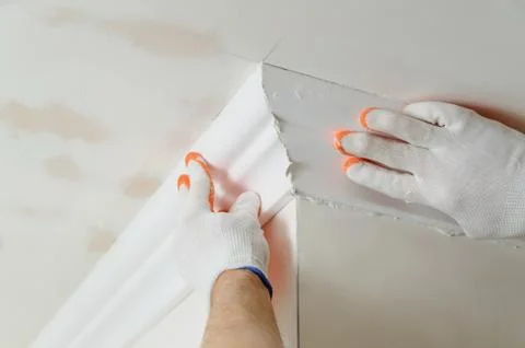 Installation of ceiling moldings. Stock Photos