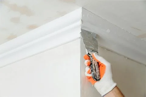 Installation of ceiling moldings. Stock Photos