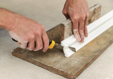 Installation of ceiling moldings. Stock Photos