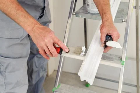 Installation of ceiling moldings. Stock Photos