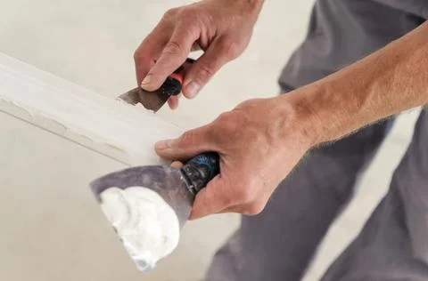 Installation of ceiling moldings. Stock Photos
