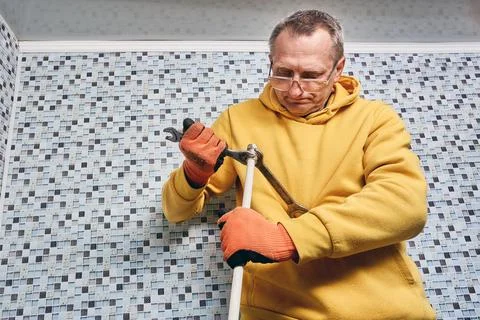 Installation of compression fitting on composite pipe is performed by plumb.. Stock Photos