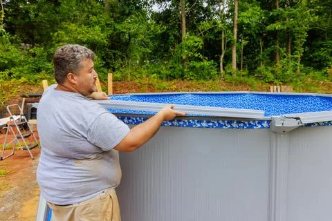 Installation of construction ground swimming pool in backyard of a house Stock Photos