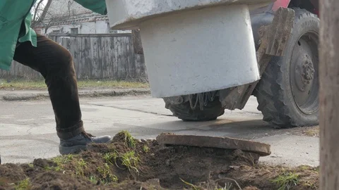 Installation of covers of cable shafts. Using an excavator tractor. Stock Footage 126759976