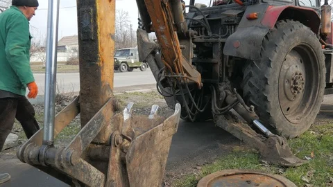 Installation of covers of cable shafts. Using an excavator tractor. Stock Footage 127107907