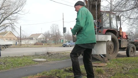 Installation of covers of cable shafts. Using an excavator tractor. Stock Footage 127110084