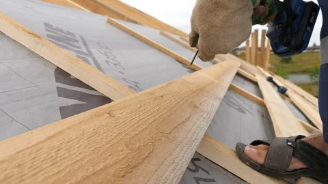 Installation of a crate of a private house. Screwing screws into a wooden Stock-Footage 280359048