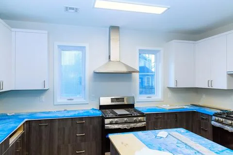 Installation of custom kitchen cabinets white color in new house Stock Photos