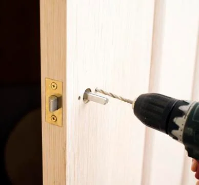 Installation of door lock Stock Photos