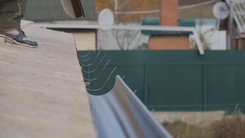 Installation of drainage system of a private house. The laying of gutters on the Stock Footage 119387022