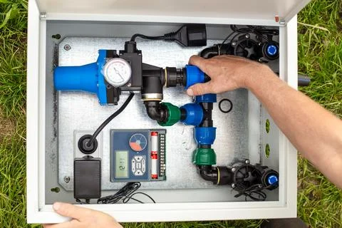 Installation of a drip irrigation system. A man assembles a system for auto.. Фото