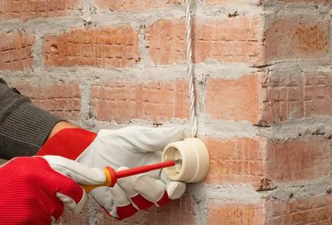 Installation of electrical outlets in retro style on a brick wall Stock Photos